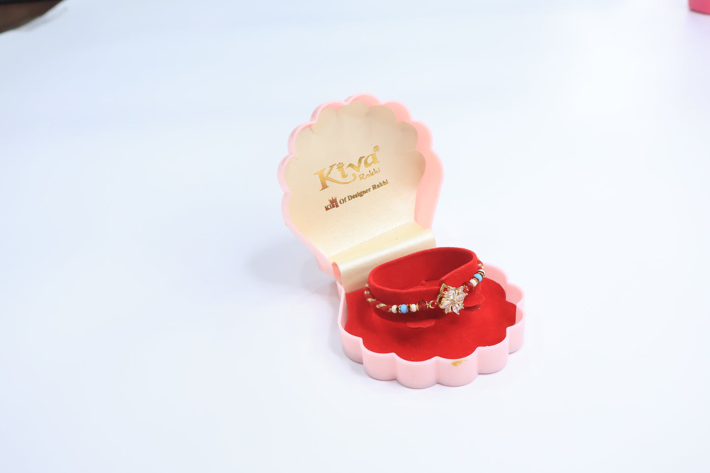 Elegant Floral Sparkle Rakhi with Red & Blue Beads