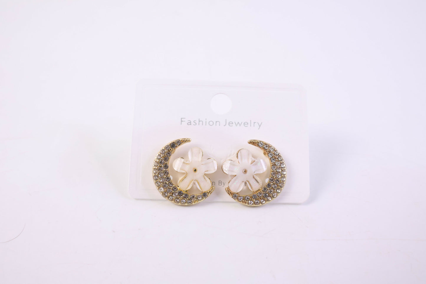 Gold moon and flower crystal stud earrings on white background