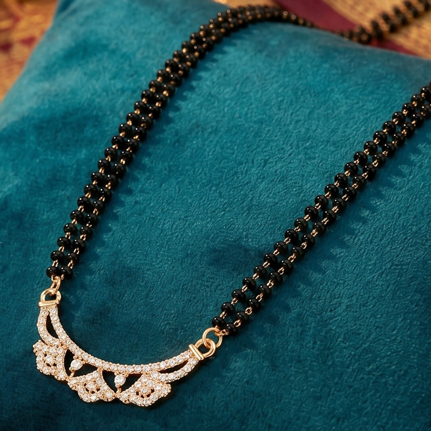 Front view of double-strand black bead chain with floral CZ pendent