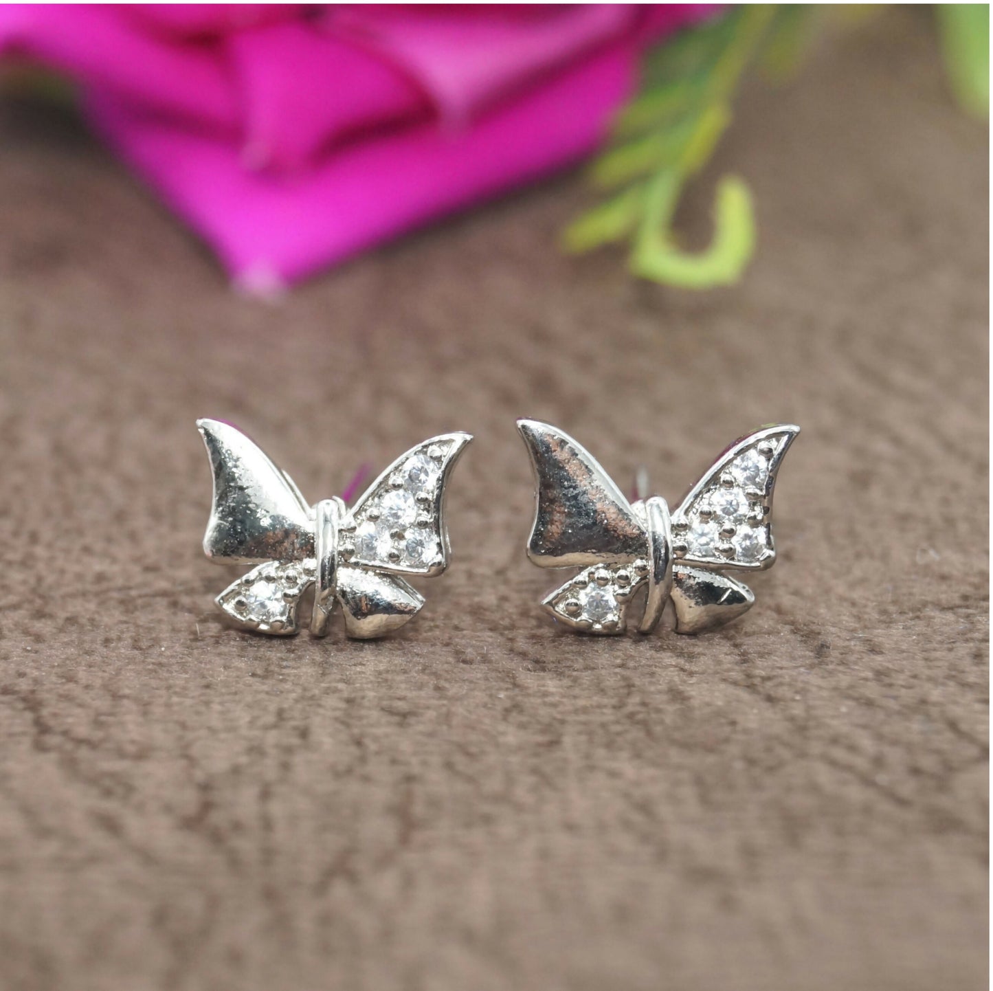 Close-up of sterling silver butterfly stud earrings showcasing elegant design and sparkle