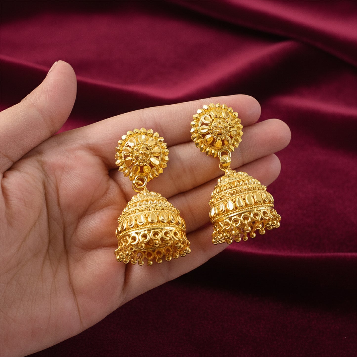 Close-up of detailed traditional design on gold plated jhumka earrings