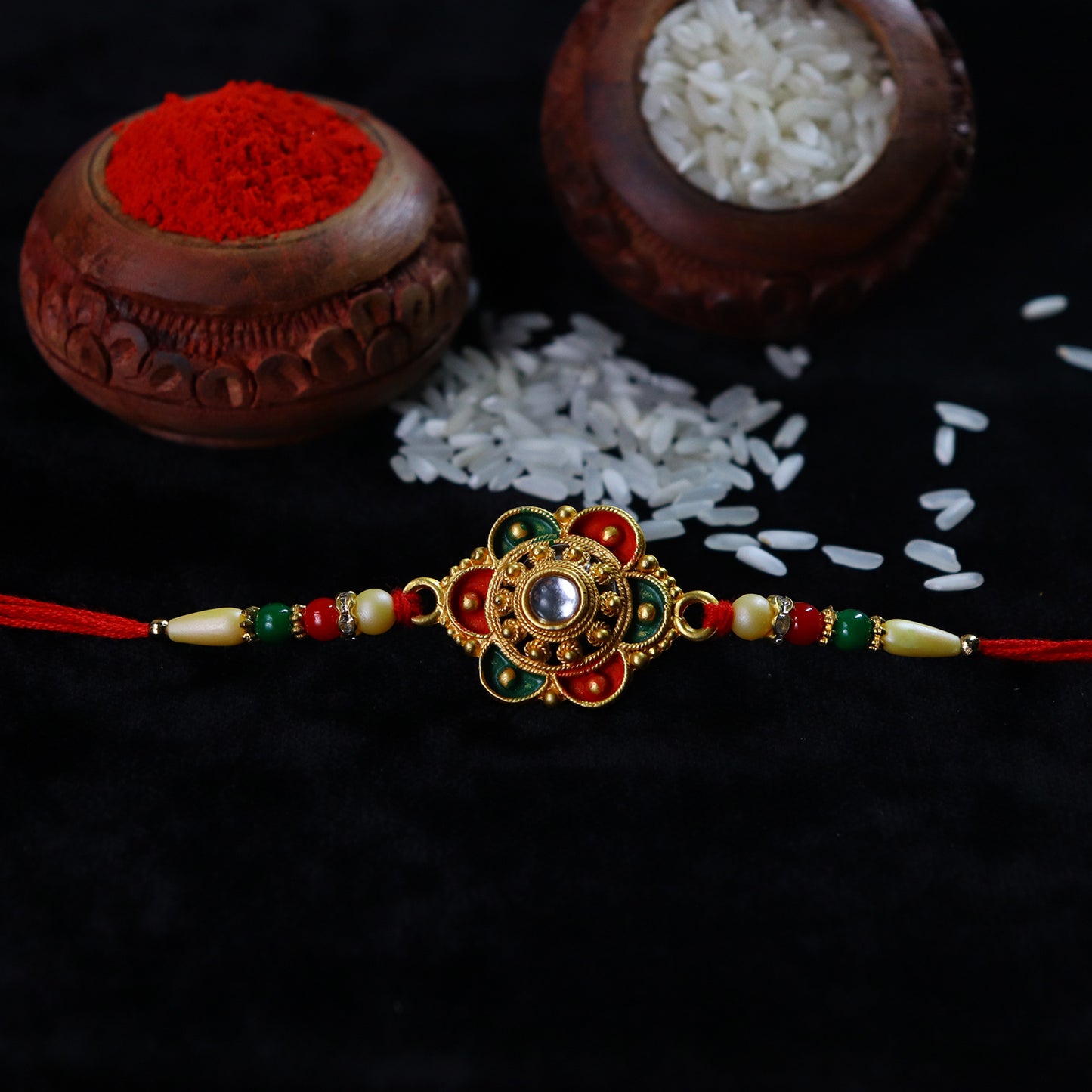 Traditional Indian handcrafted rakhi with floral stone and enamel detailing