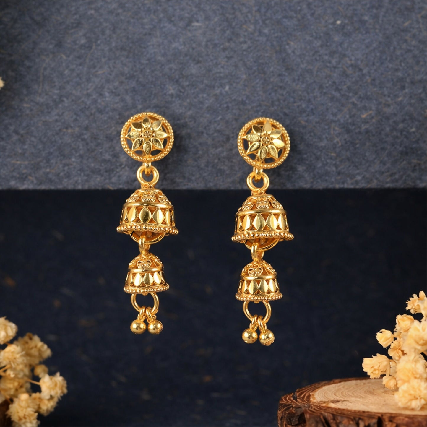 Traditional gold tone jhumka earrings with floral studs and layered drops
