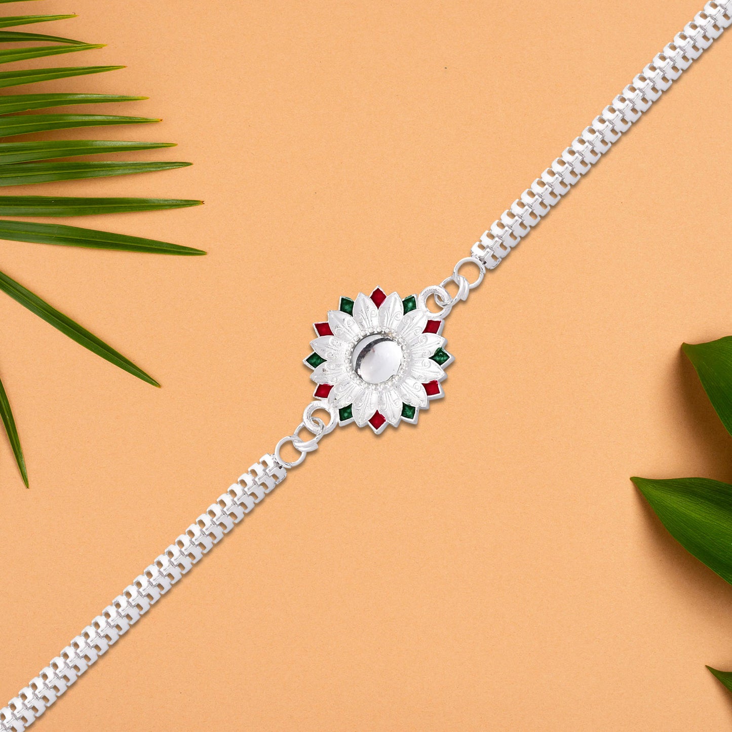 Elegant Silver-Plated Floral Rakhi with Red and Green Meenakari Accents