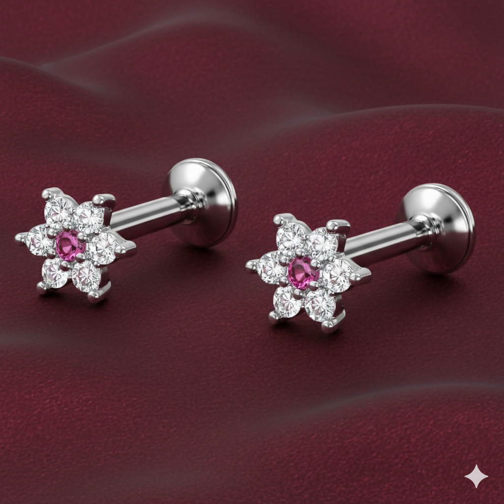 Close-up of silver-plated ruby and crystal floral stud earring for cartilage piercings