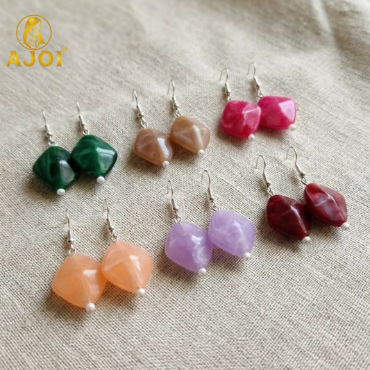 Colorful geometric stone drop earrings on white background