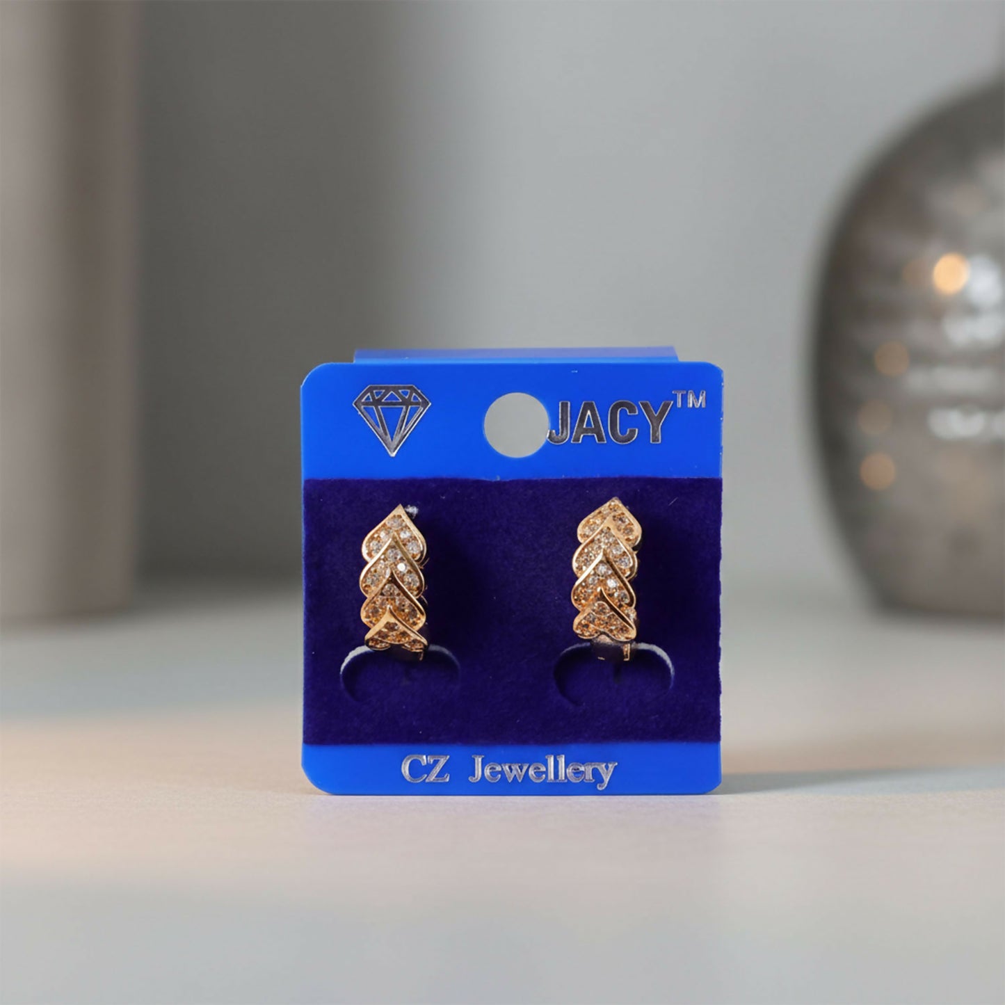 Elegant gold finish stud earrings shaped like layered leaves with stone detailing
