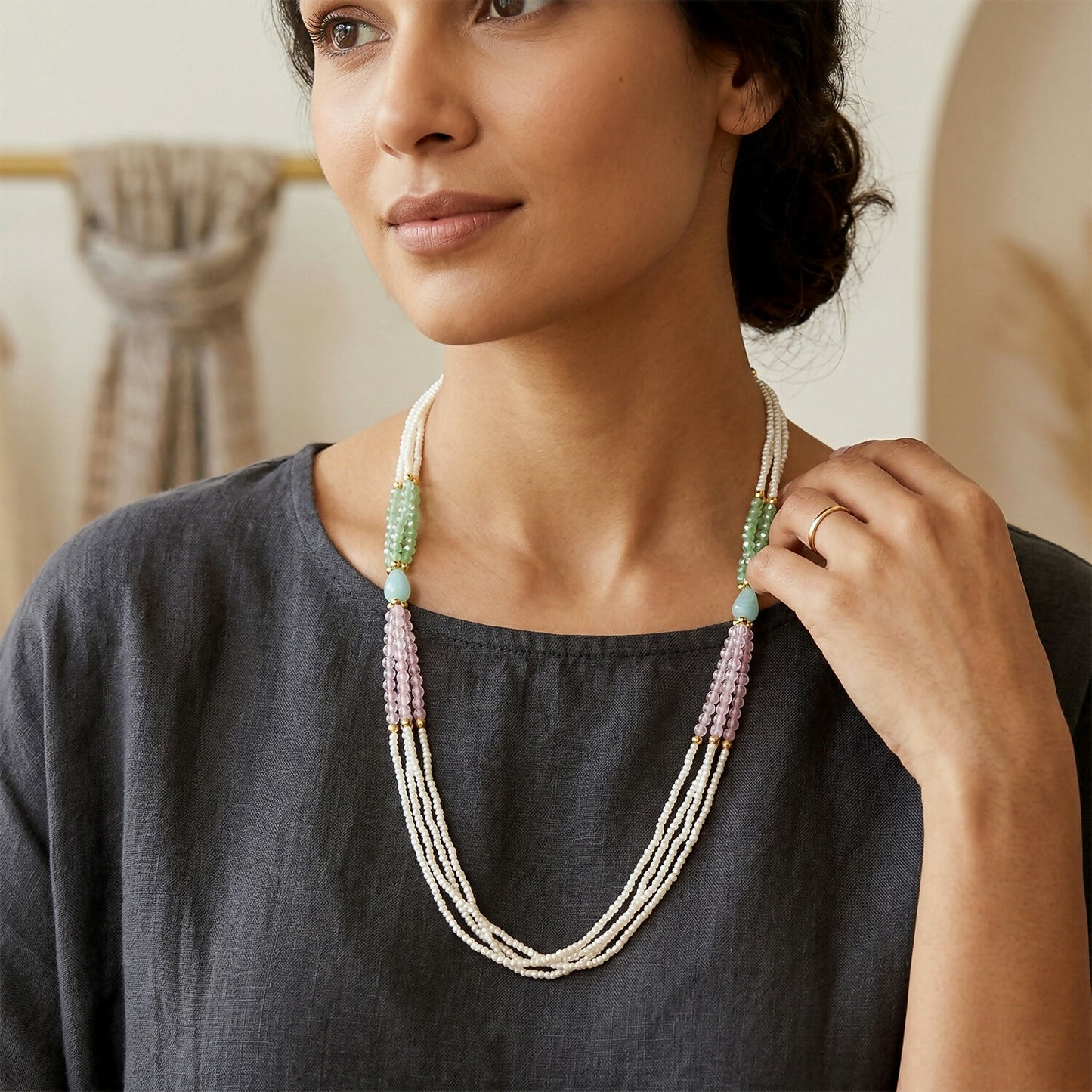 Close-up detail of layered pearl and bead mala necklace