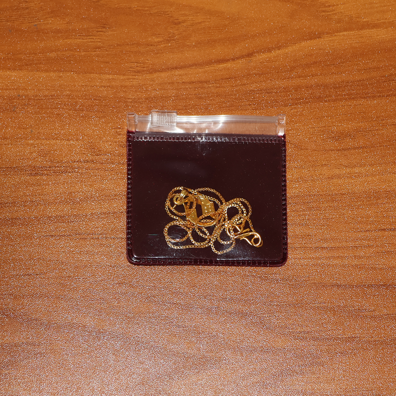 Lifestyle image of elegant twist pendant necklace worn with formal attire