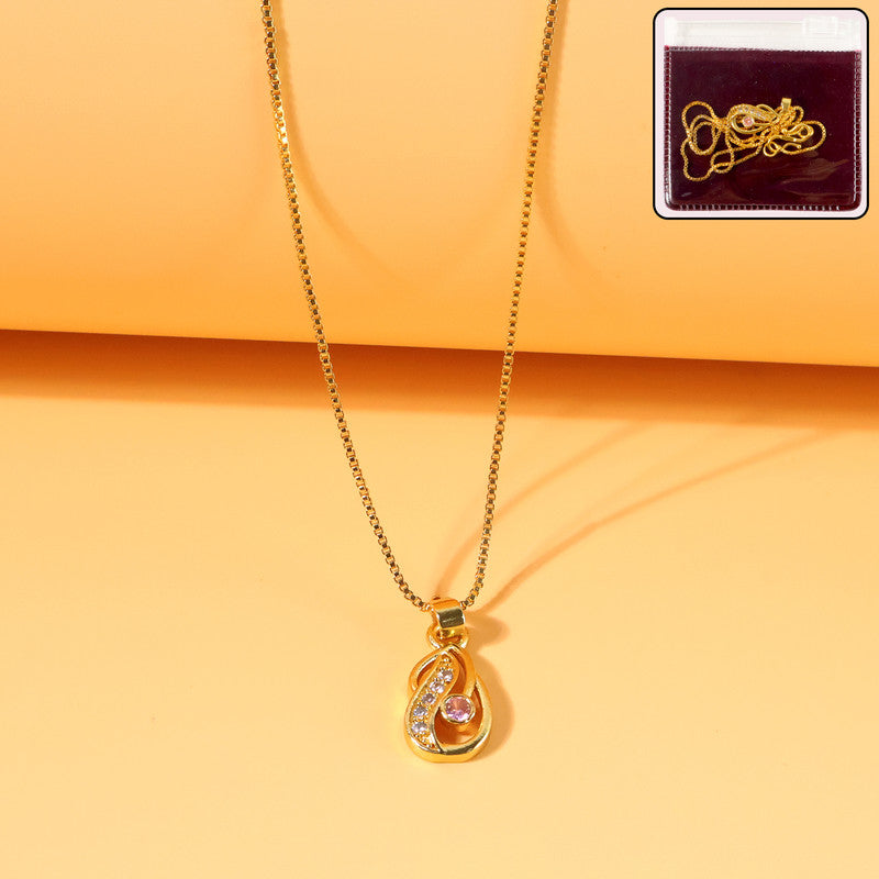 Close-up of gold-plated tear-drop pendant necklace featuring pink stone and crystals