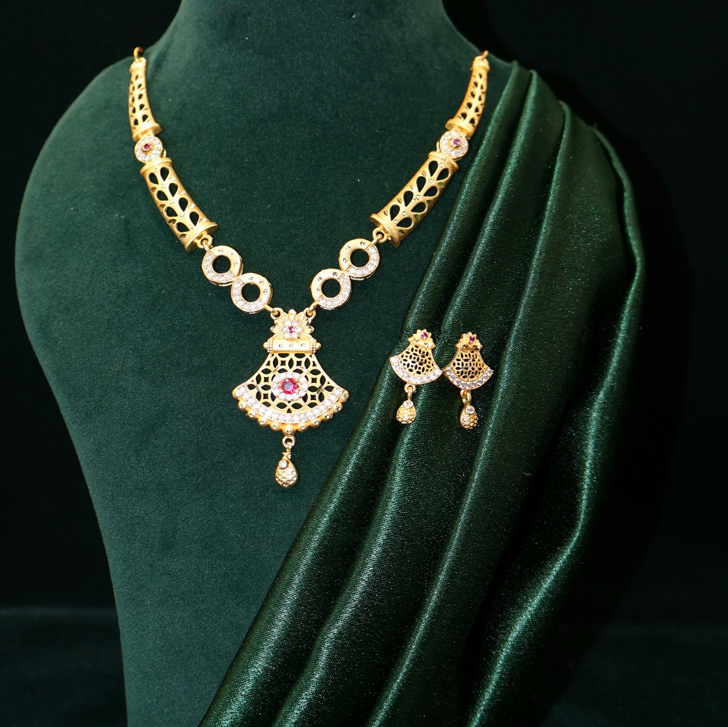 Matching gold plated jhumka earrings paired with bridal necklace set
