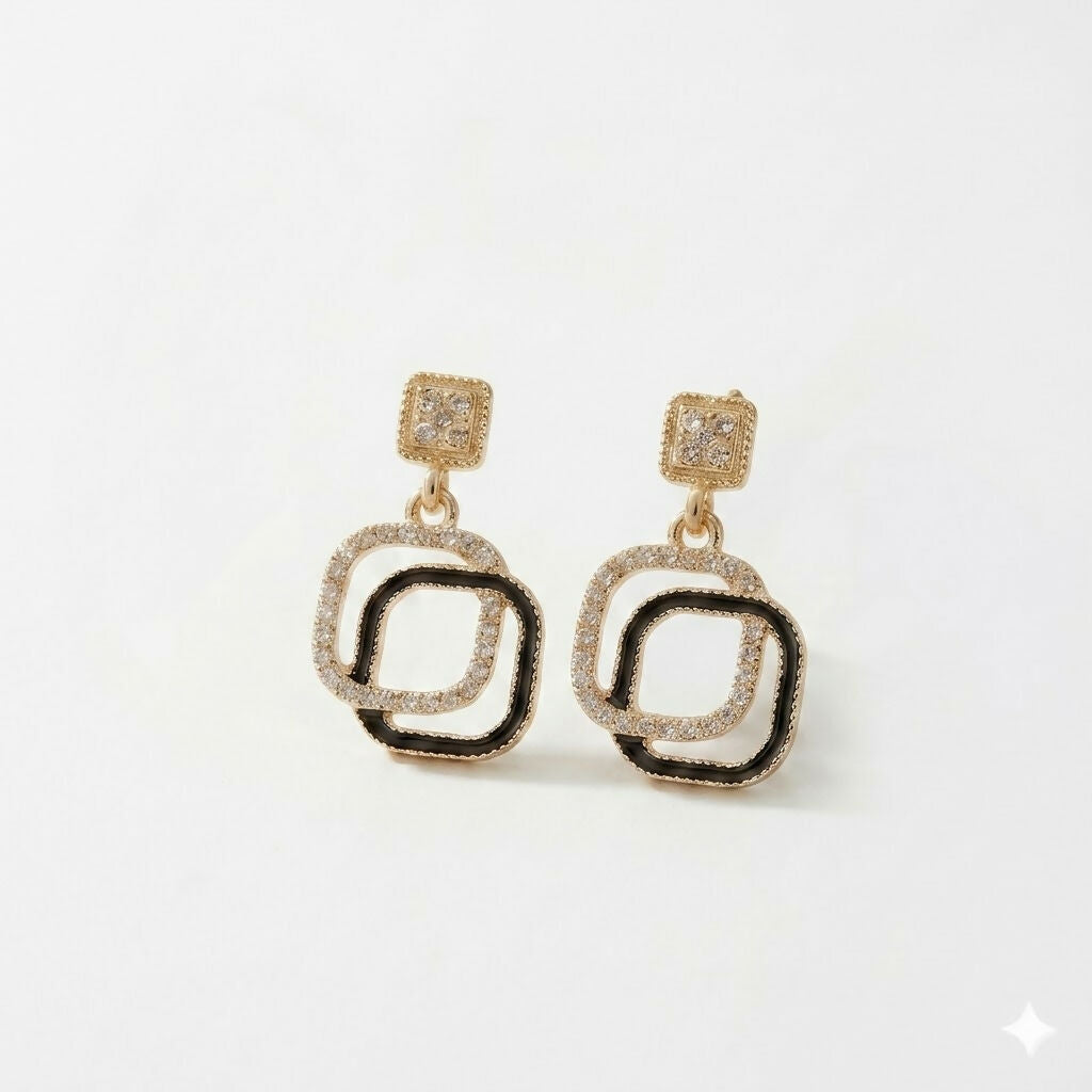 Close-up of elegant geometric earrings with black stone and rhinestones