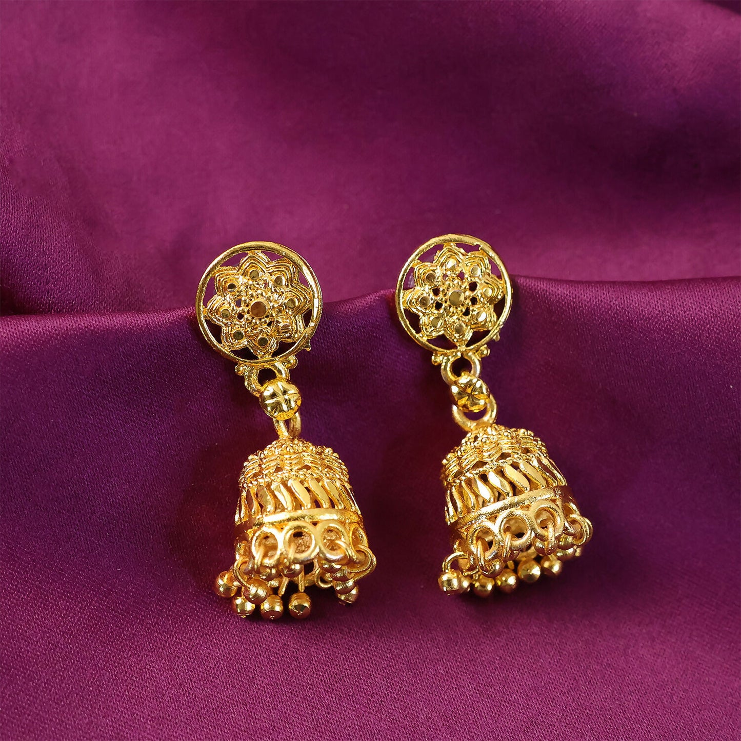 Side view of gold plated floral jhumka earrings