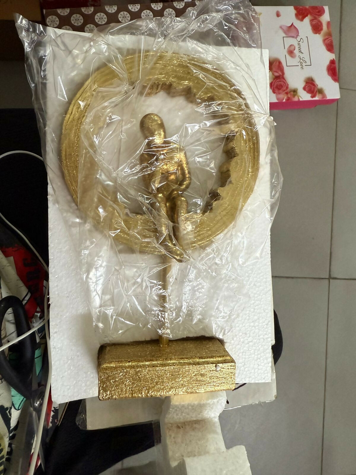 Abstract gold thinking man figurine on table
