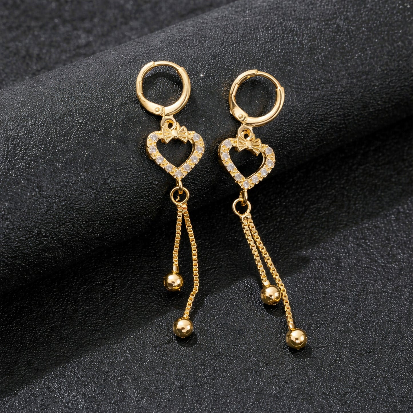 Heart shape drop earrings with sparkling stones and gold-finish chain tassels