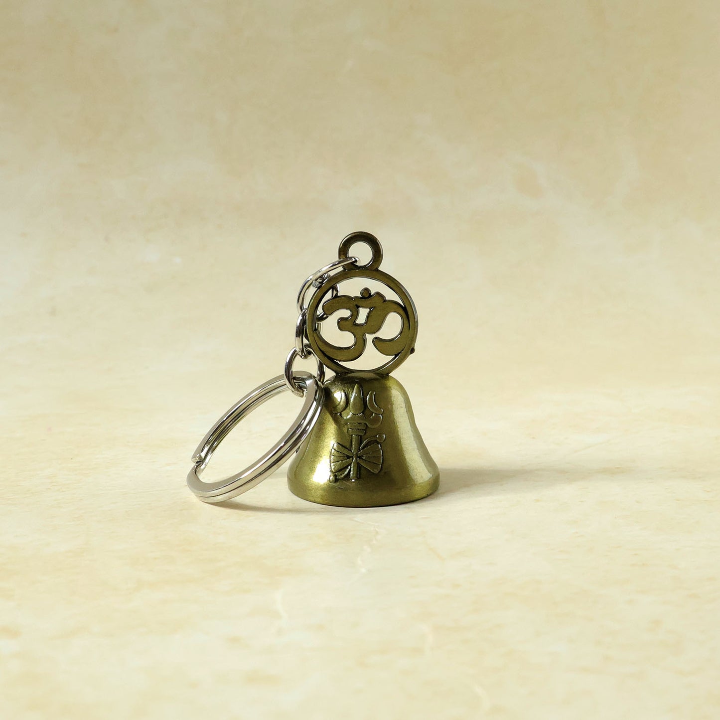 Om temple bell keychain used as a decorative bag charm