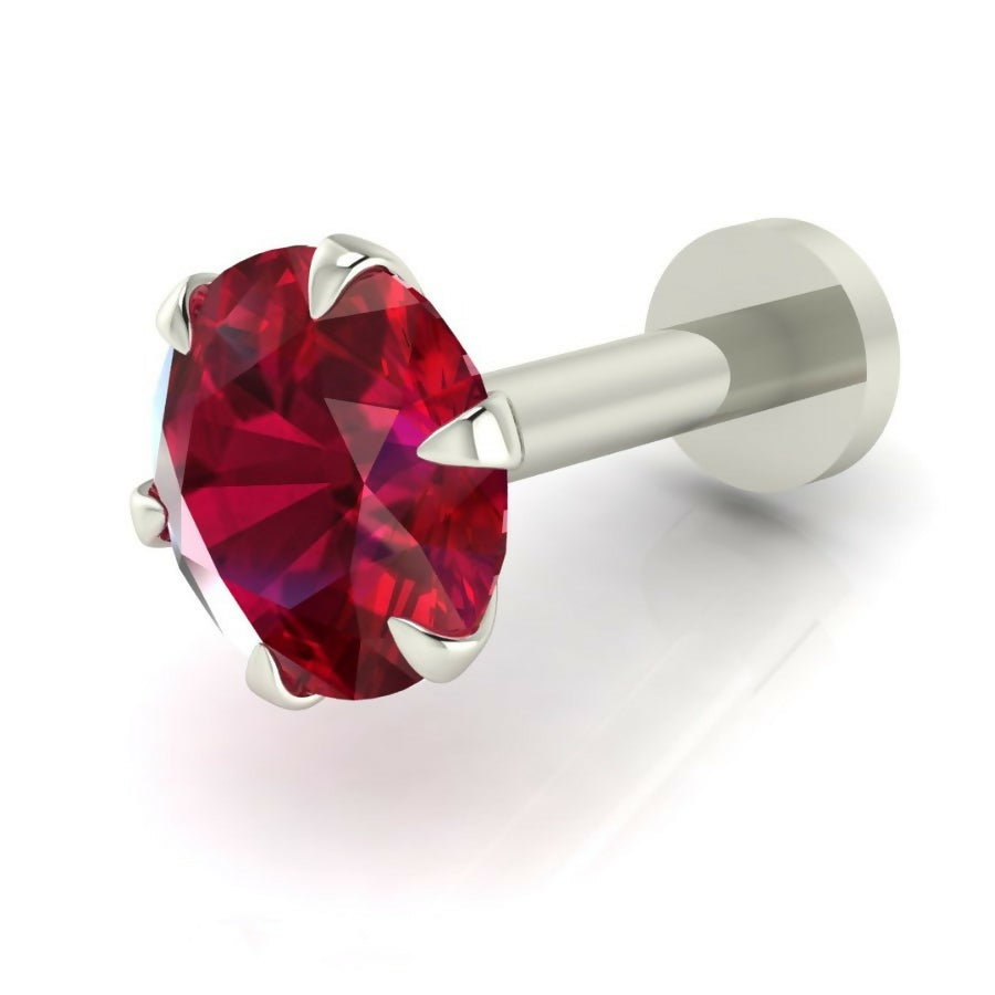 Angle view of silver plated nose stud featuring bright red ruby gemstone