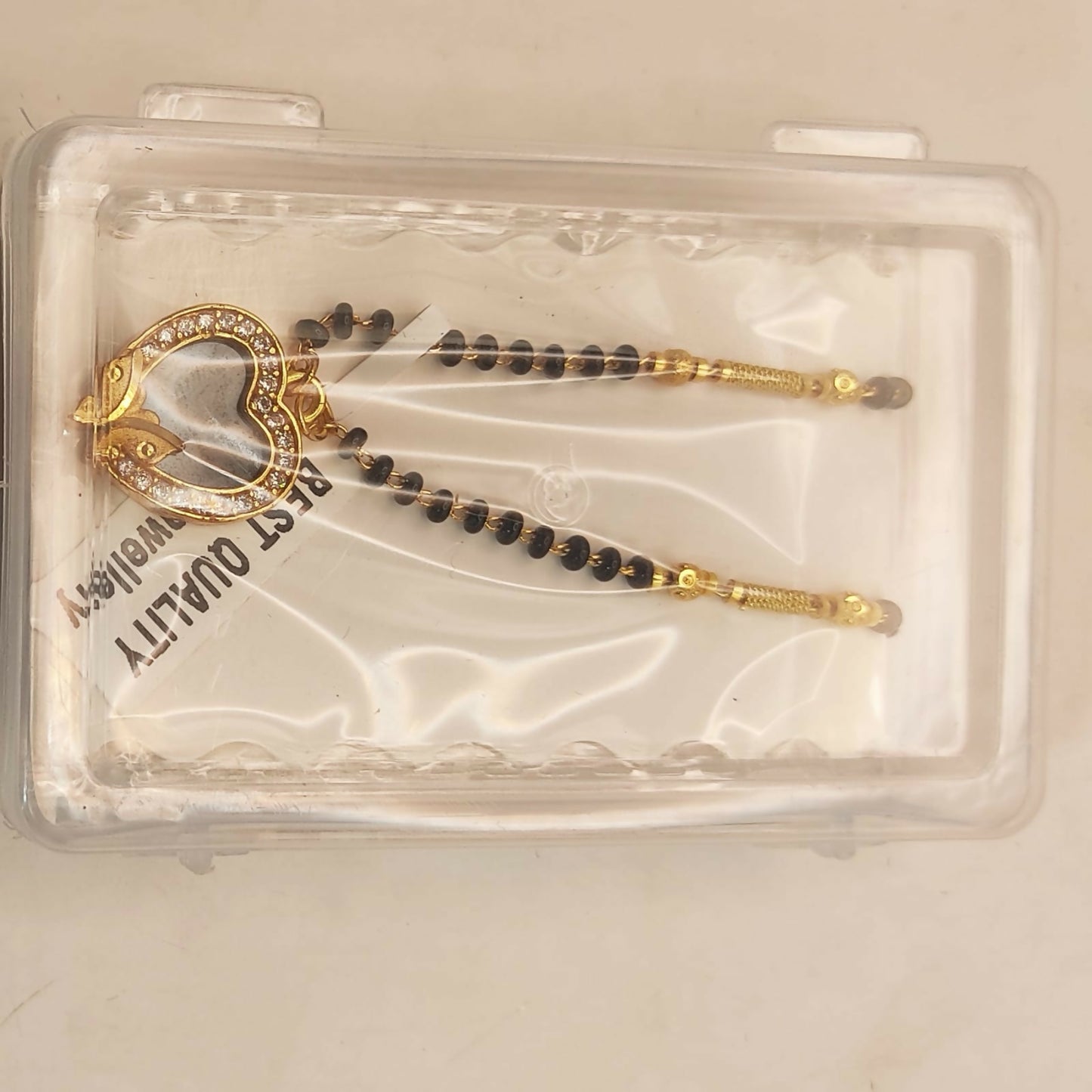 Elegant Mangal Sutra featuring gold-plated heart pendant with black enamel butterfly