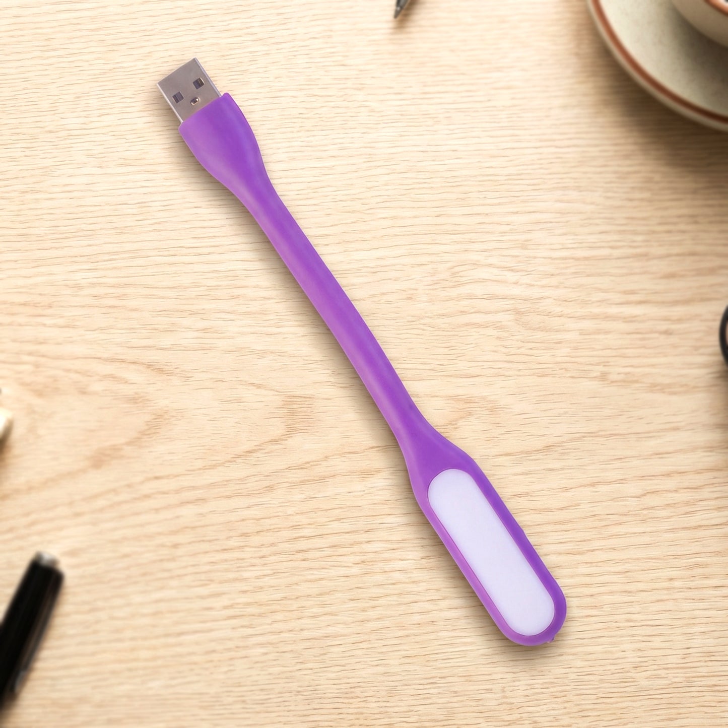 Flexible USB LED light positioned over laptop keyboard