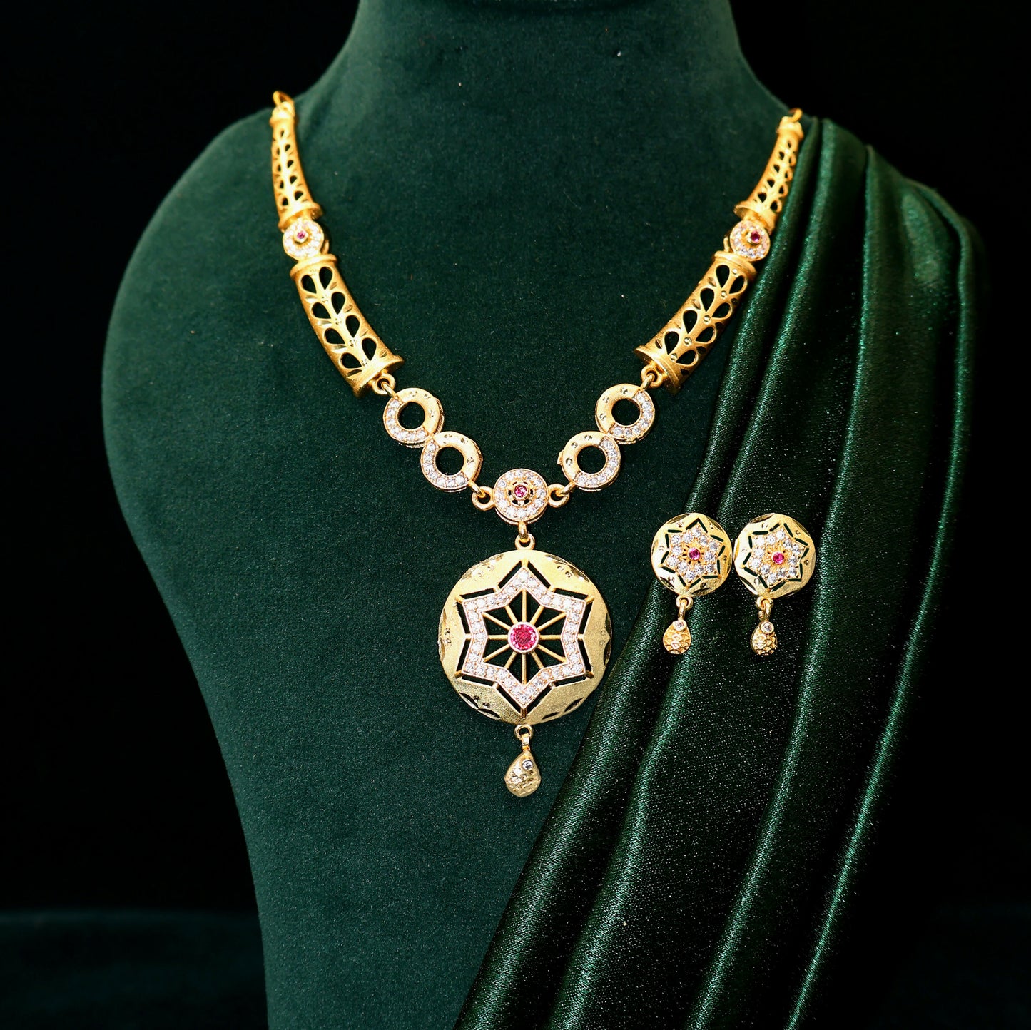 Close-up view of gold plated star pendant adorned with ruby and cubic zirconia stones