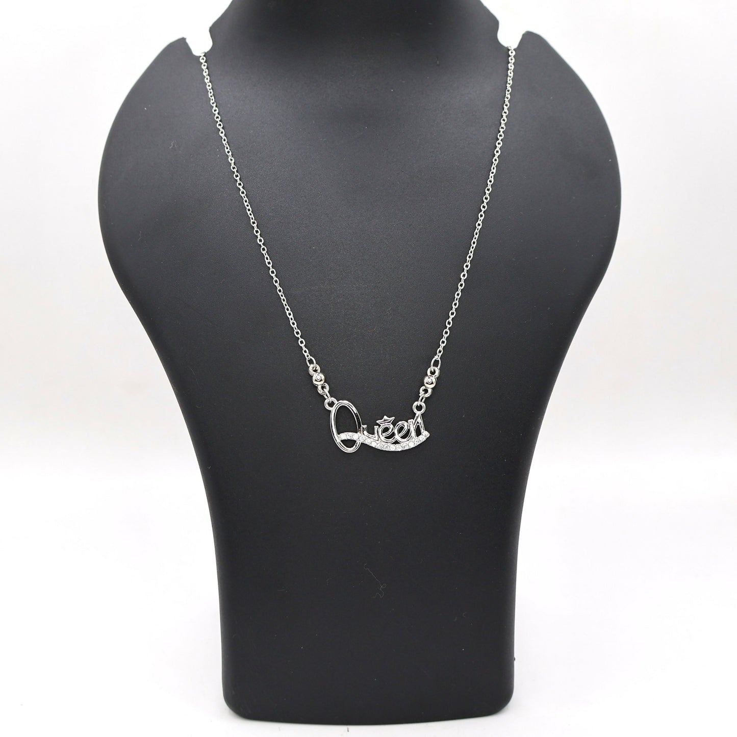Model wearing Queen pendant necklace in silver tone showcasing sparkling Cubic Zirconia