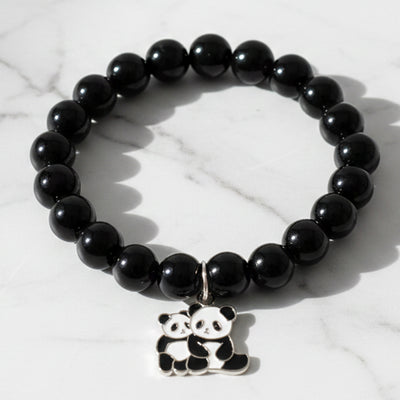Black beaded stretch bracelet with an adorable panda charm on white background.