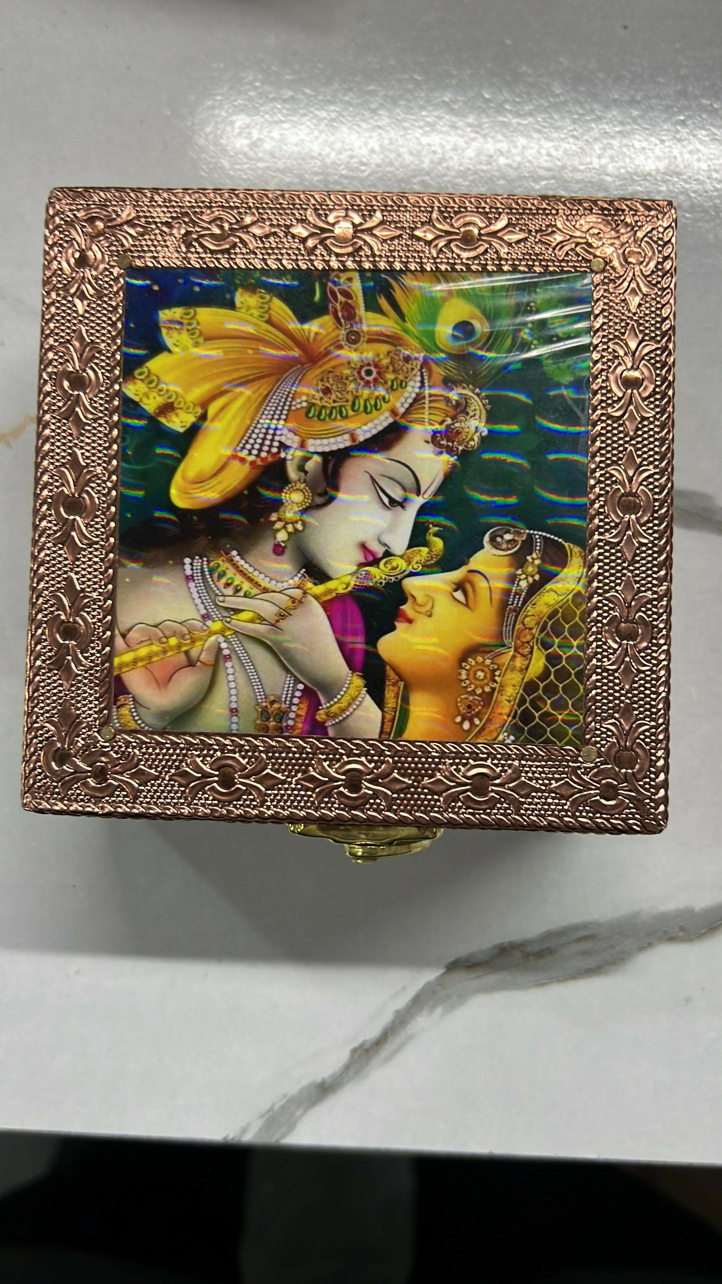 Upright view of copper-finished wooden jewelry box with intricate details