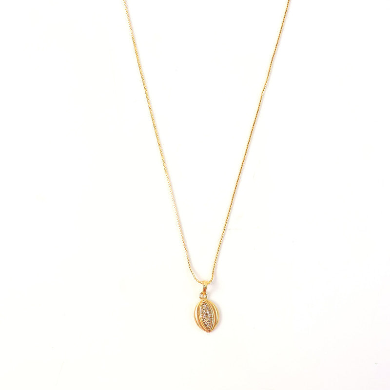 Side angle of gold-plated pendant necklace highlighting detailed edge texture and stone accents