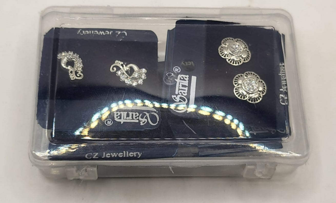 Display of four pairs of sterling silver stud earrings including butterfly, floral, heart, and peacock designs