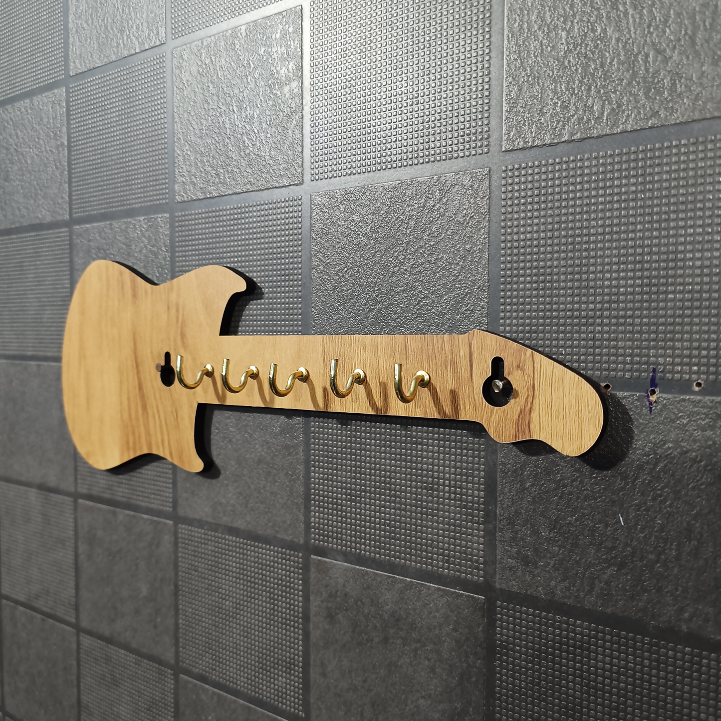 Close-up of wooden guitar key holder hooks and finish