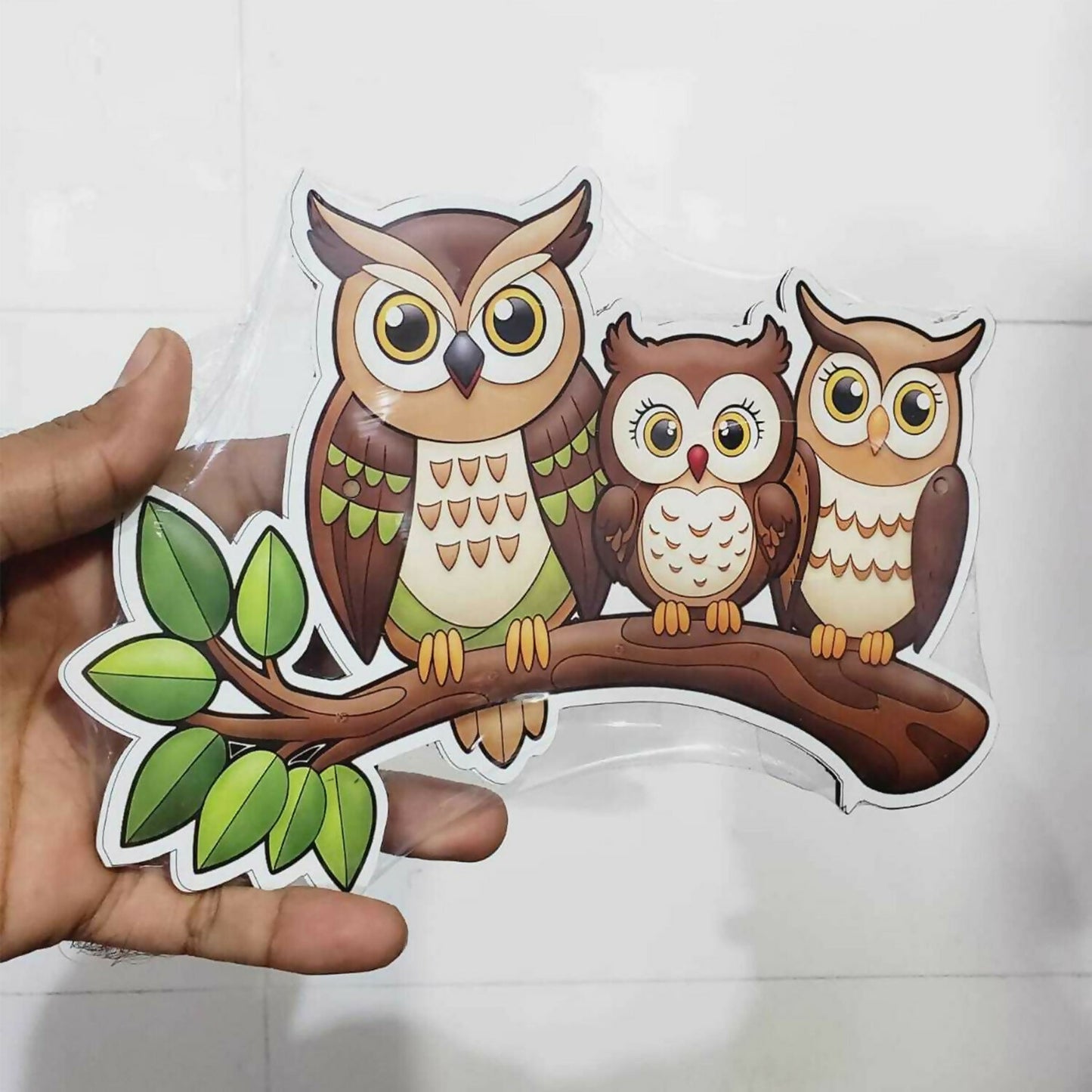 Decorative owl key holder mounted above a console table