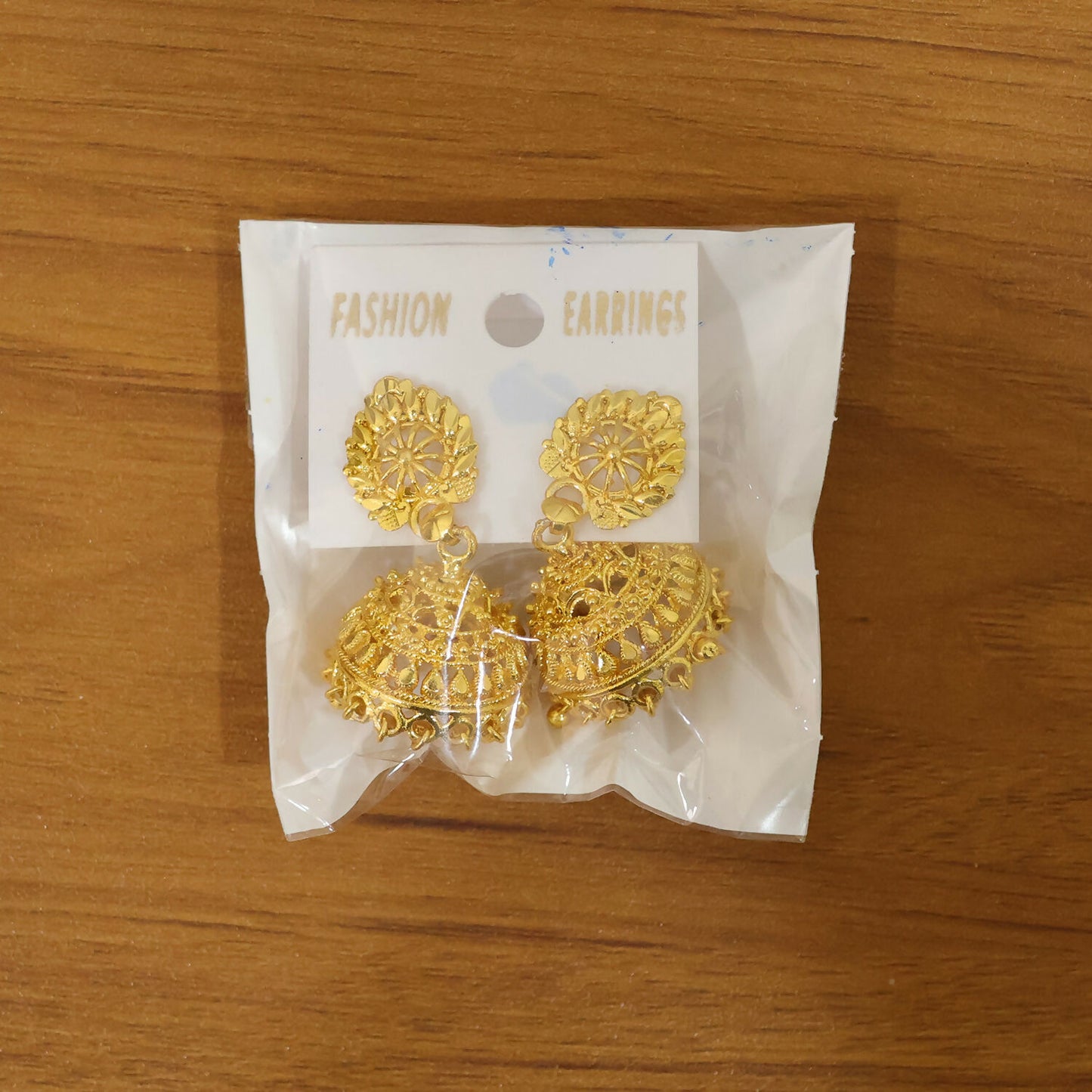 Hanging gold dome jhumka earrings designed for traditional wear