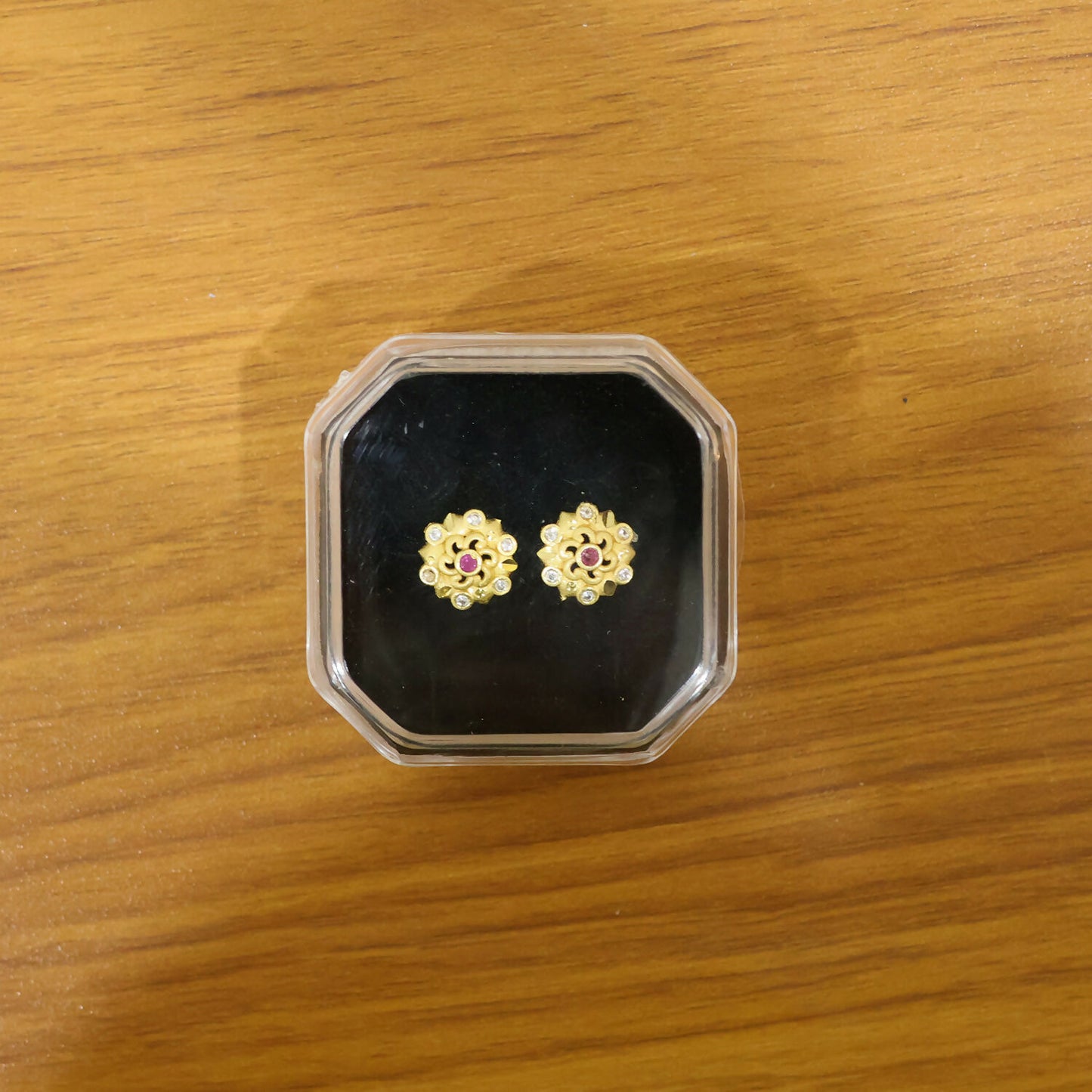 Styled gold floral earrings with multi-stone embellishments