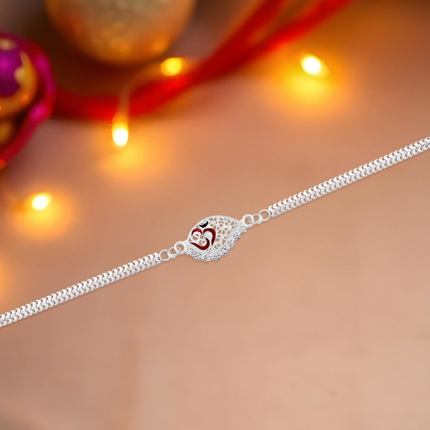 Designer Silver Plated Rakhi close-up with Om symbol