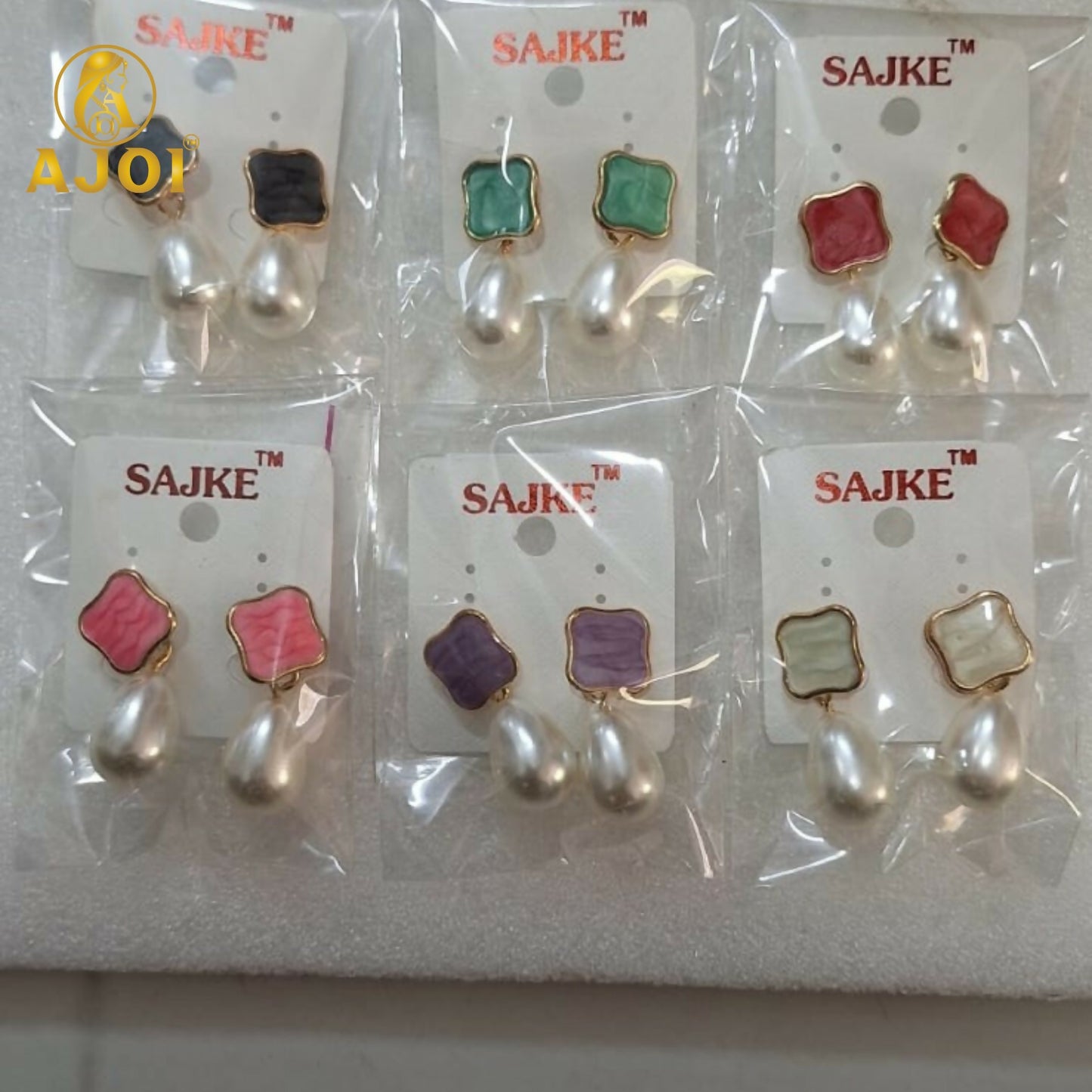 Multiple pearl Tilak earrings with lustrous teardrop pearls and pastel accents