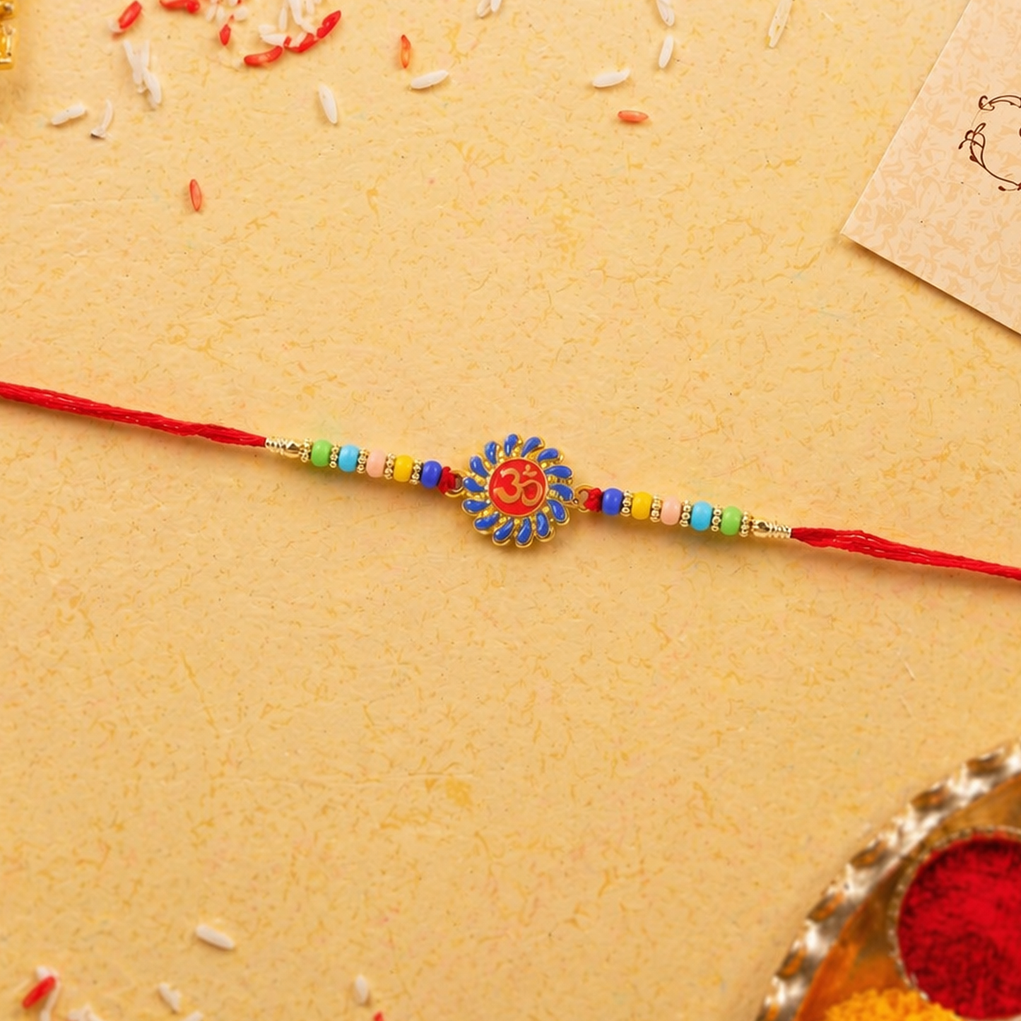 Om Designer Rakhi displaying soft decorative beads and thread in detail