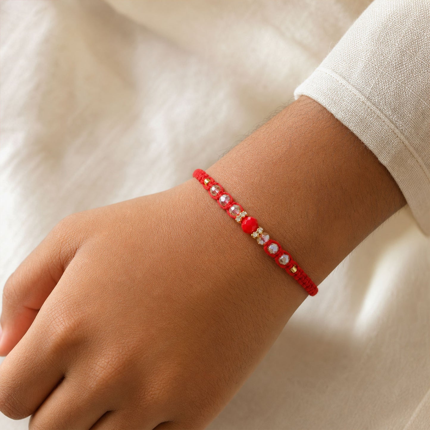 Red Braided Rakhi with a Row of Sparkling Crystal Bead Accents