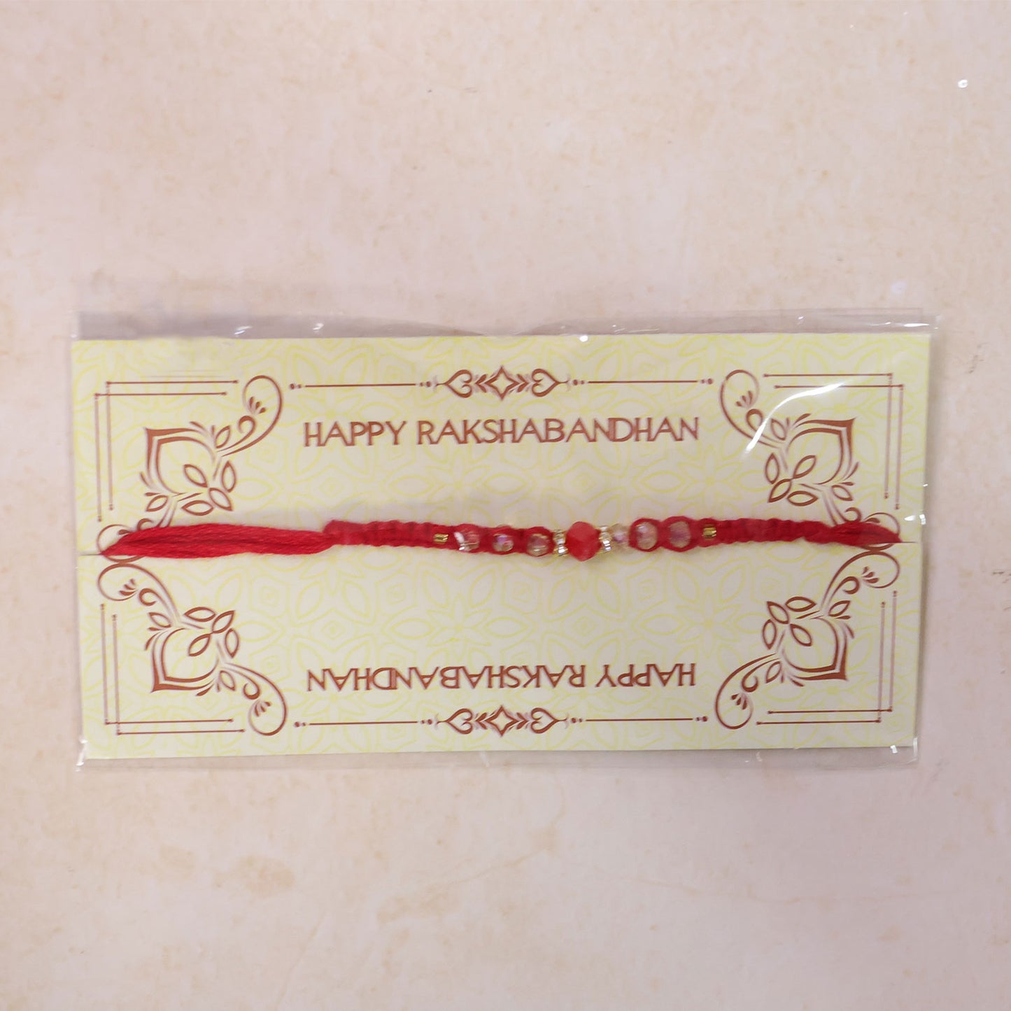 Red Braided Rakhi with a Row of Sparkling Crystal Bead Accents
