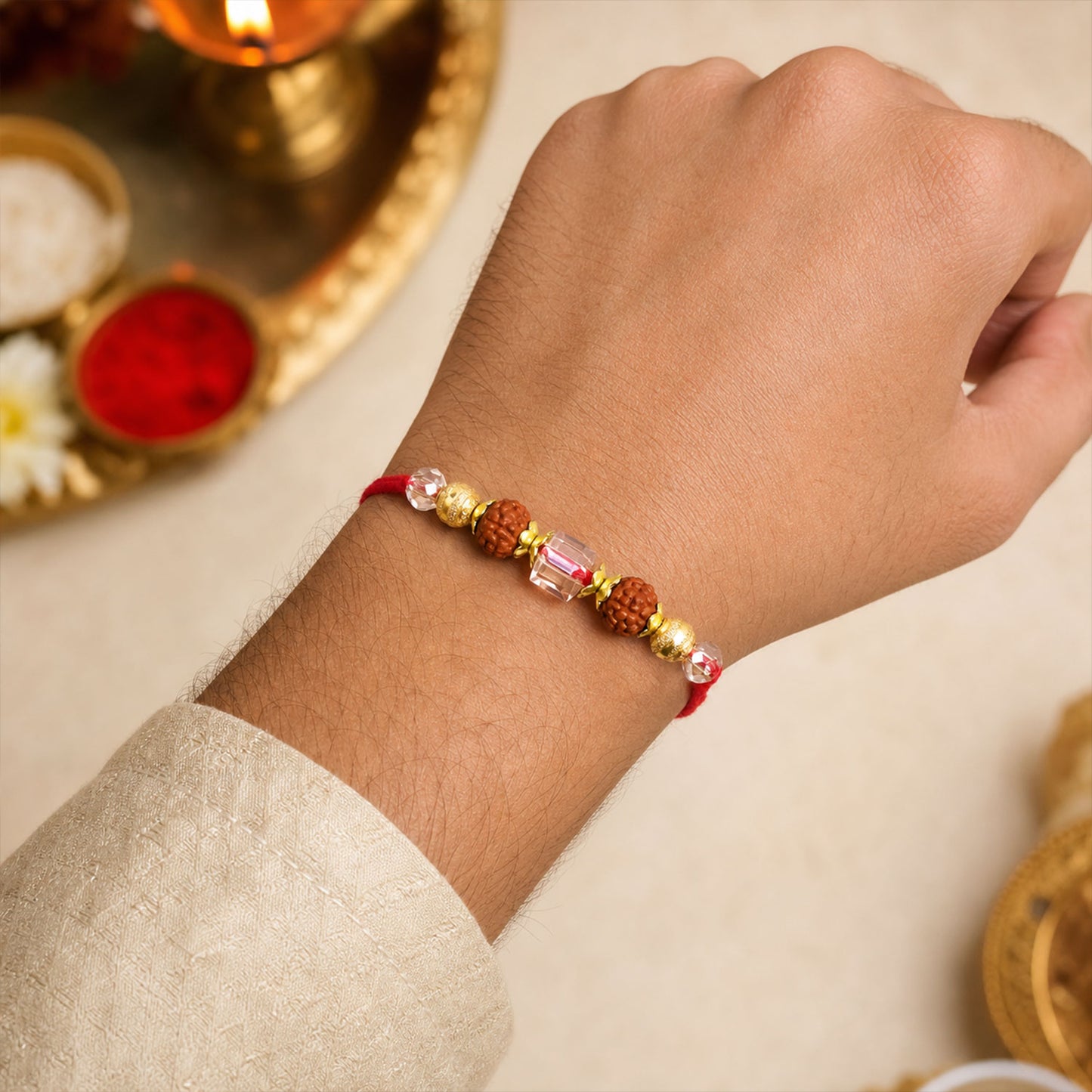 Red Thread Rakhi with Rudraksha and Sparkling Crystal Bead Accents