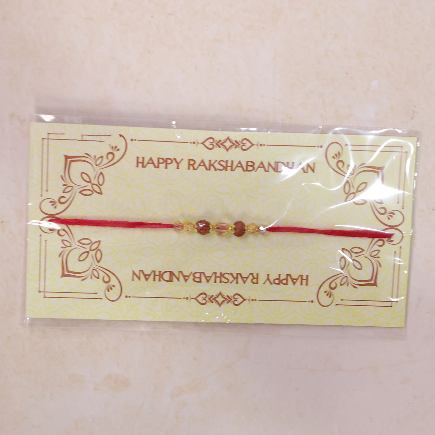 Red Thread Rakhi with Rudraksha and Sparkling Crystal Bead Accents