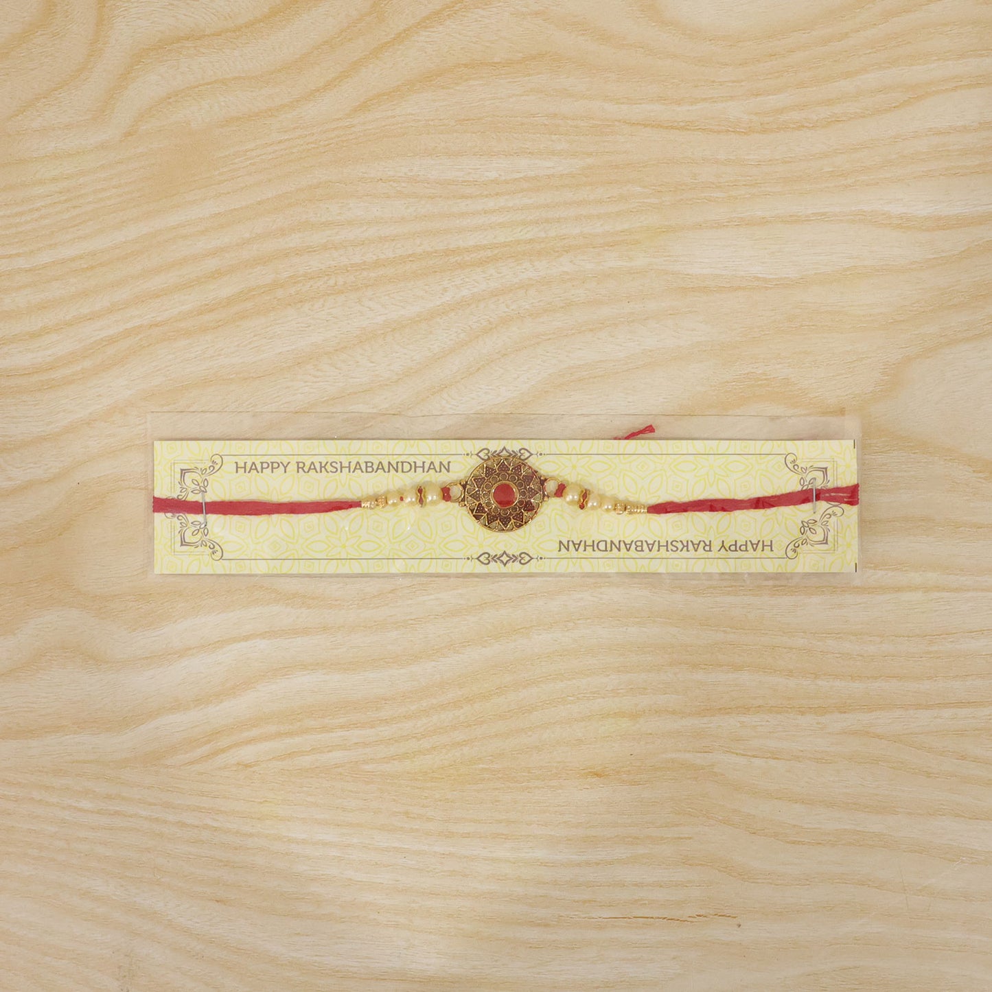 Premium Traditional Rakhi – Red Stone & Pearl Beads Elegant Design