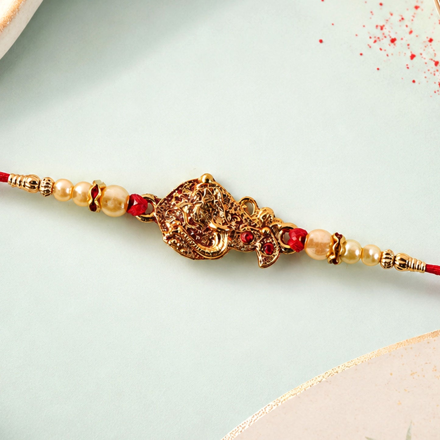 Golden Peacock Rakhi – Elegant Pearl Beads & Thread Chain Rakhi for brother