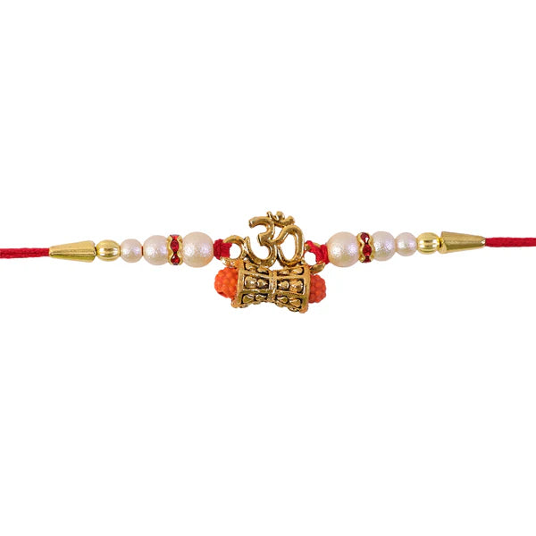 Golden Charm Rakhi presented with its red thread and pearl bead detailing.