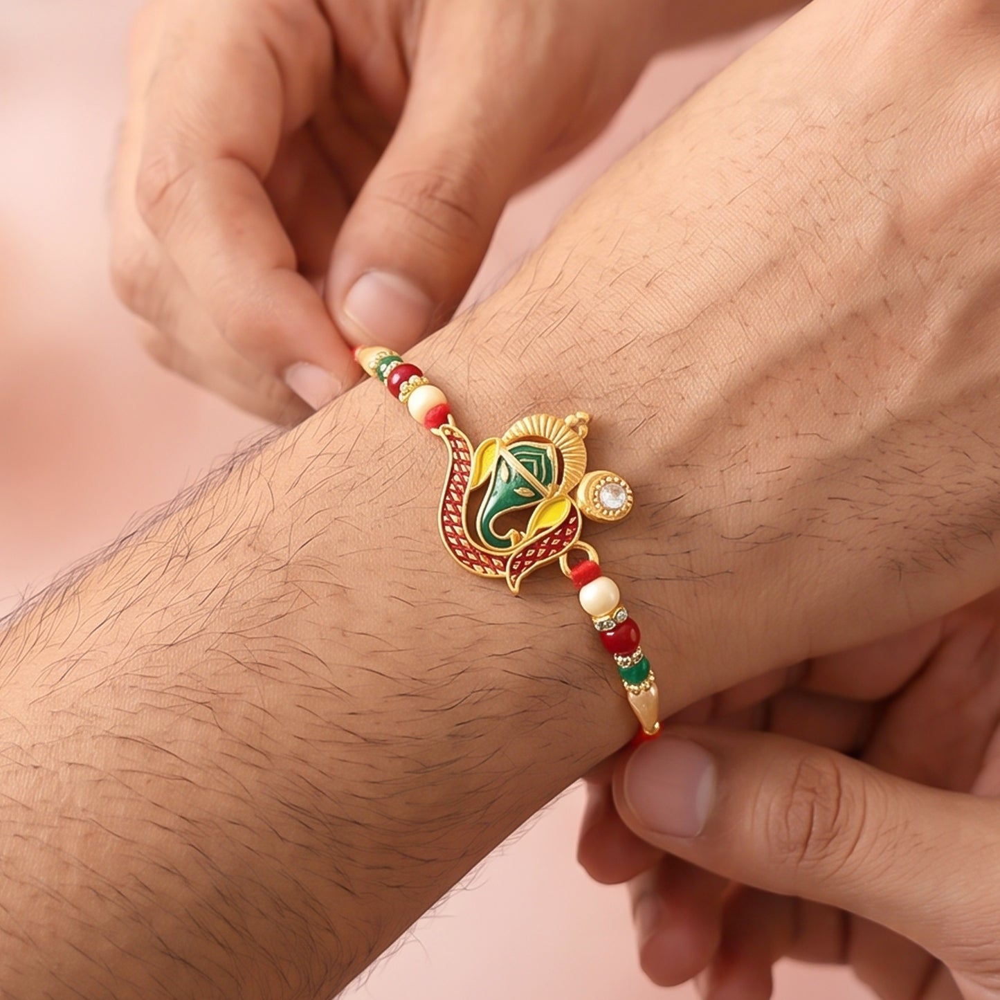 Ganesha Rakhi for brother displayed against a traditional Indian background.
