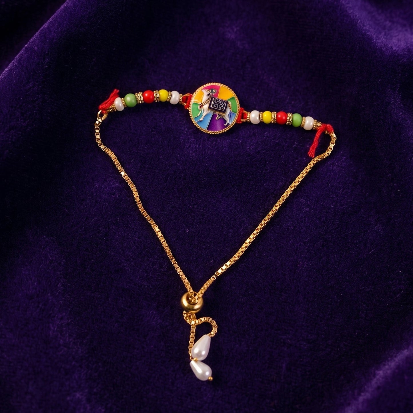 Side angle of traditional cow motif designer rakhi with beads