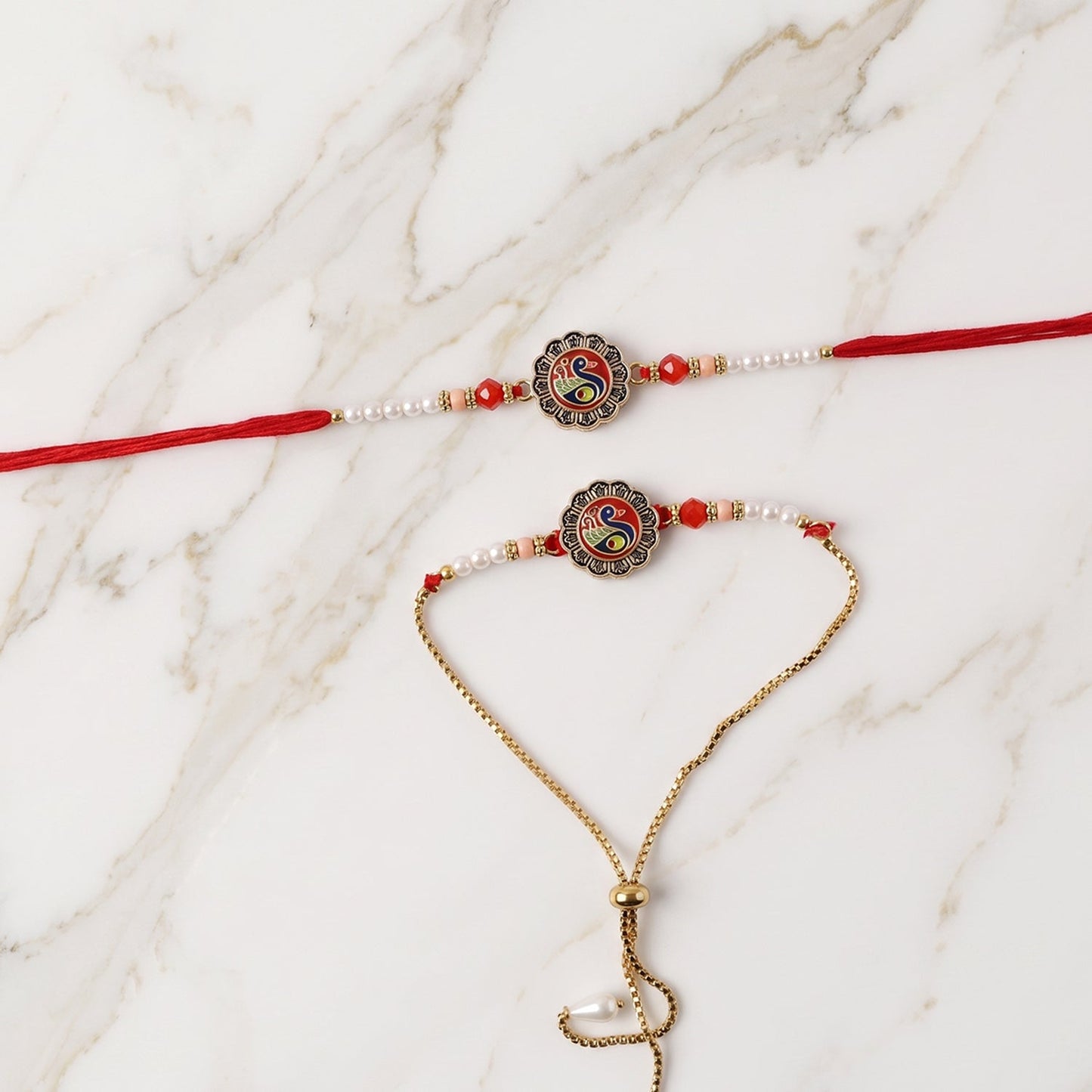Designer Rakhi close-up featuring peacock pattern and pearl beads