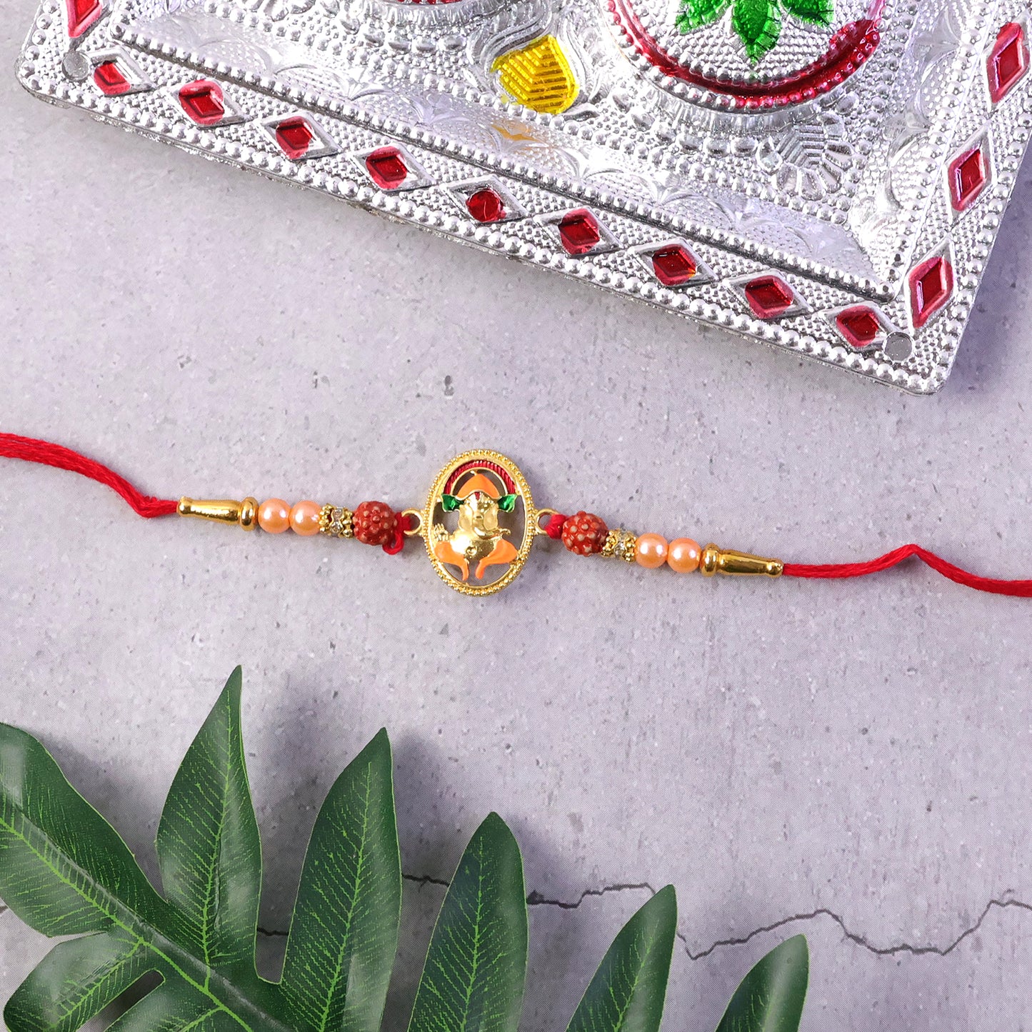 Soft thread detail on Ganesha rakhi