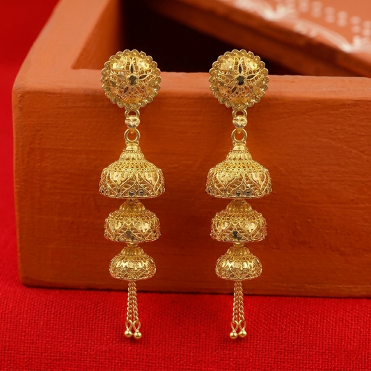 Intricate gold jhumka earrings with traditional design