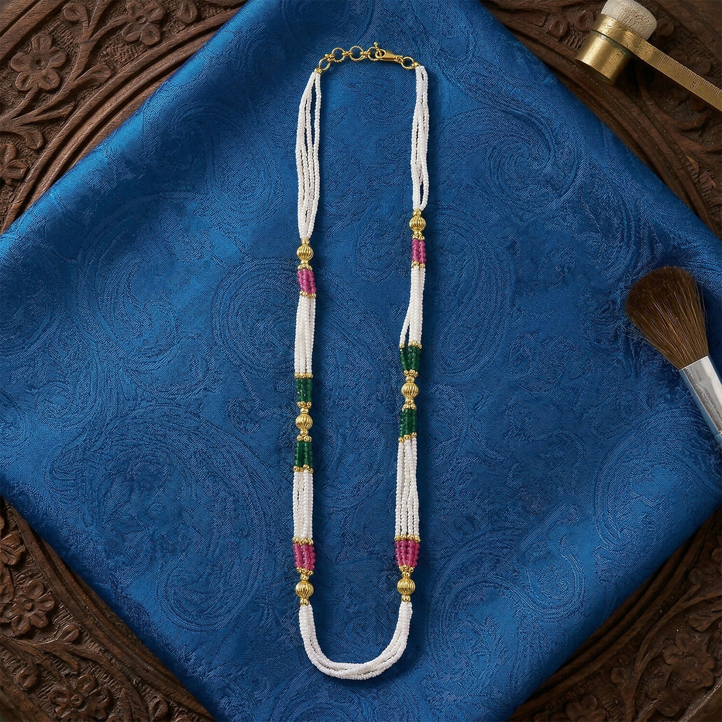 Side view of multi-layered beaded mala with gold accents