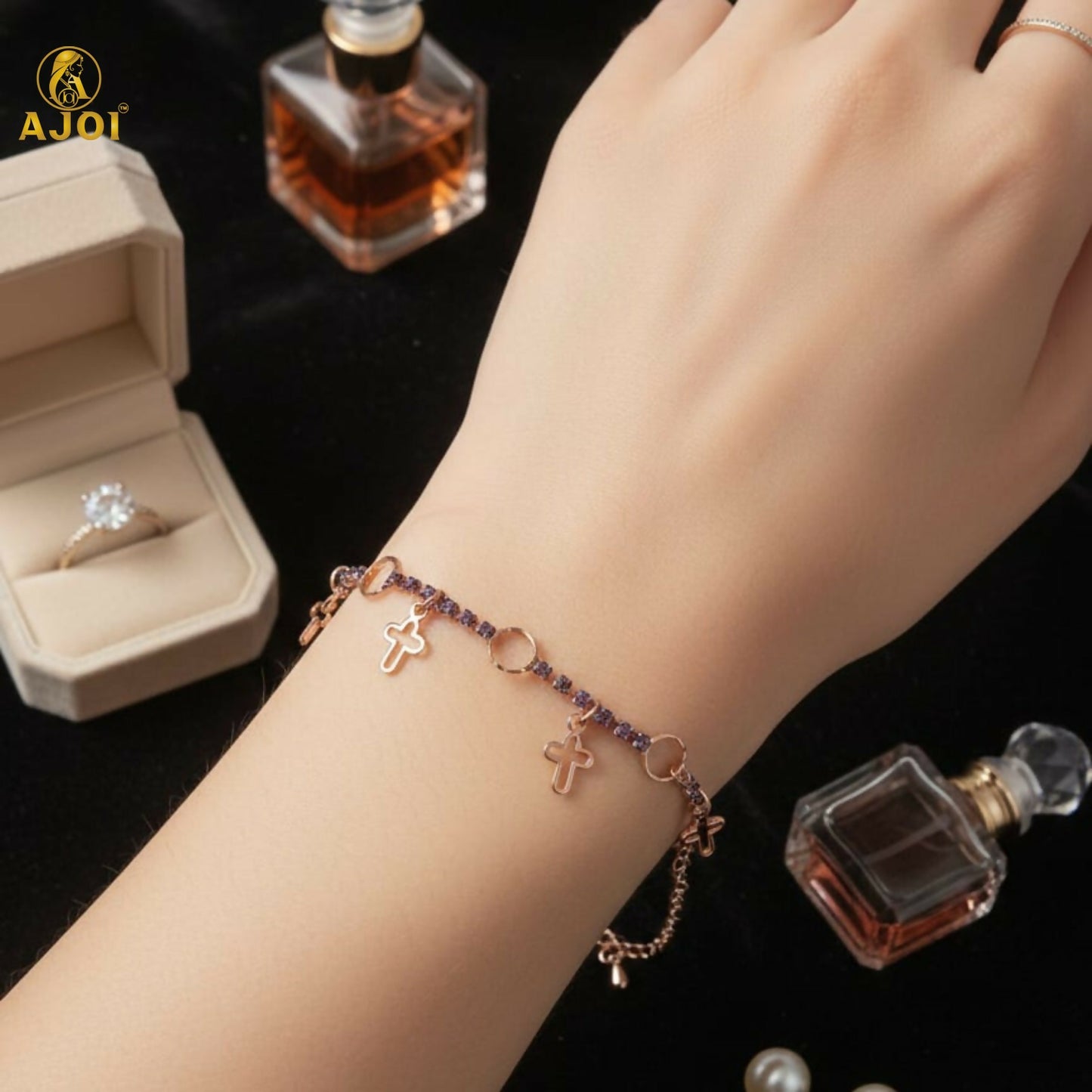 Close-up of rose gold-plated crystal charm bracelet shining under light
